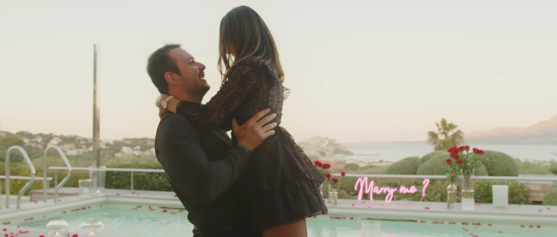 Fiancée jumping into her partner's arms after saying yes